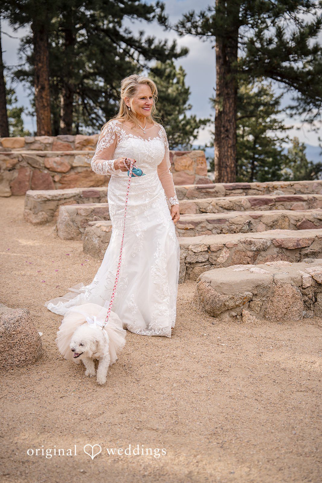 Jacquelyn + Millard Bride walking her dog in her wedding gown at Sunrise Amphitheater before the ceremony.
