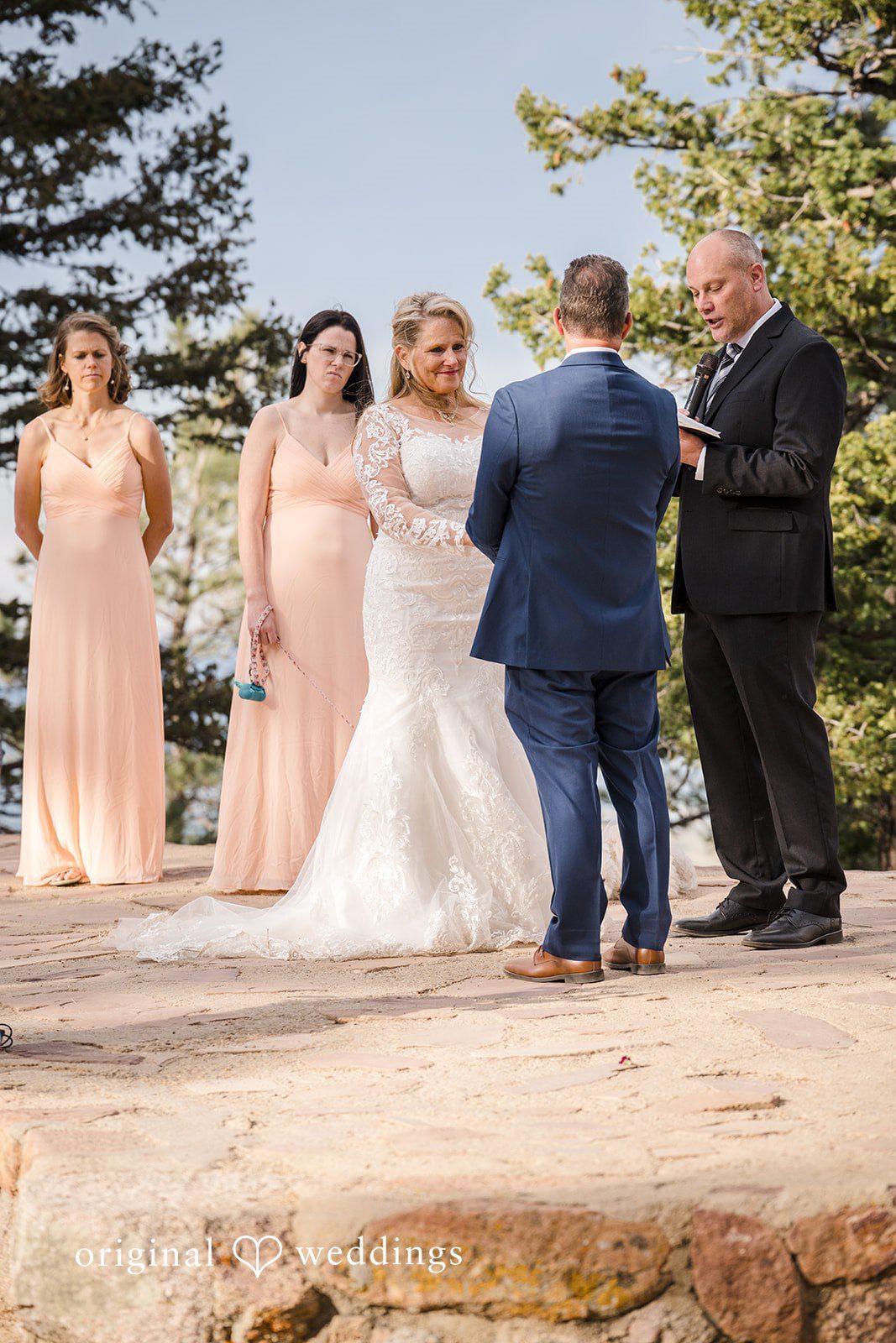 Jacquelyn + Millard Bride and groom exchanging vows surrounded by loved ones