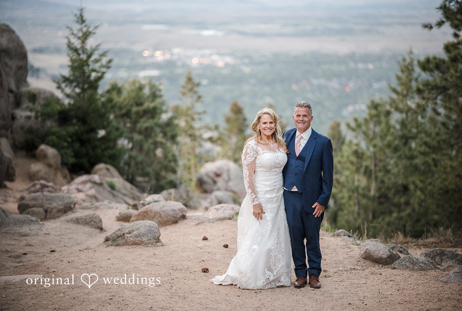 Couple portrait with mountain views and pine trees at Sunrise Amphitheater captured by Denver wedding photographers from Original Weddings