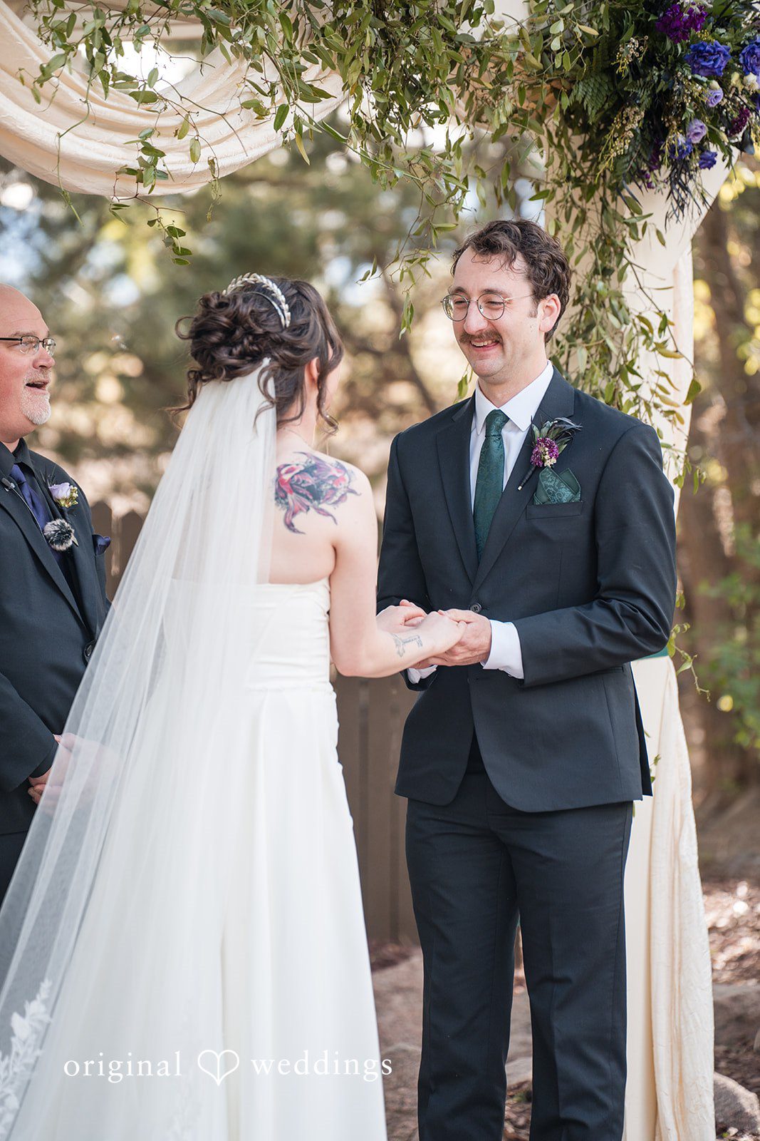 Hannah + Kyle Couple exchanging vows during ceremony, hands in hands