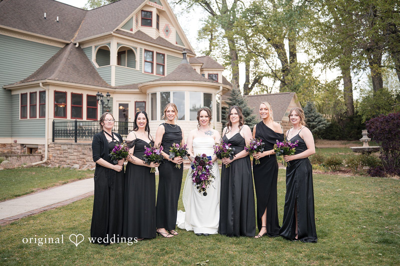 Hannah + Kyle Group shot of bride with the bridesmaids, all holding bouquets.