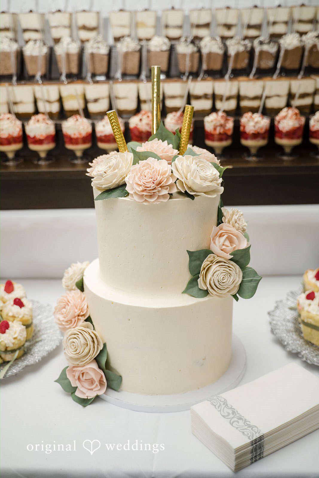 Nicole + Dalton Beautiful wedding cake picture decorated with flowers around