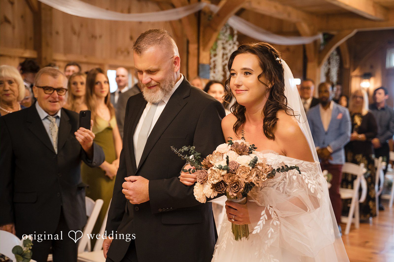 Nicole + Dalton Bride walking down the aisle with someone