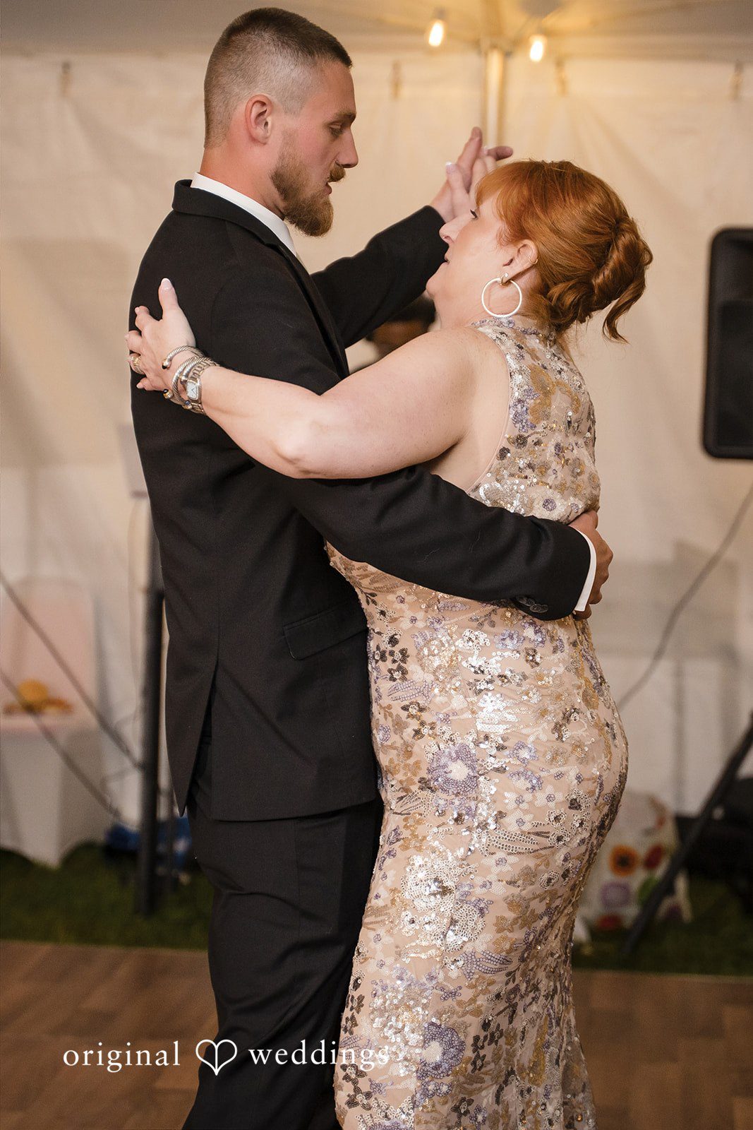 Nicole + Dalton Groom sharing a dance with someone