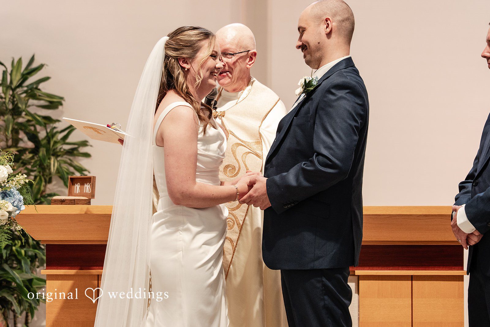 Mary Rose + Nate Bride and groom holding hands while exchanging vows