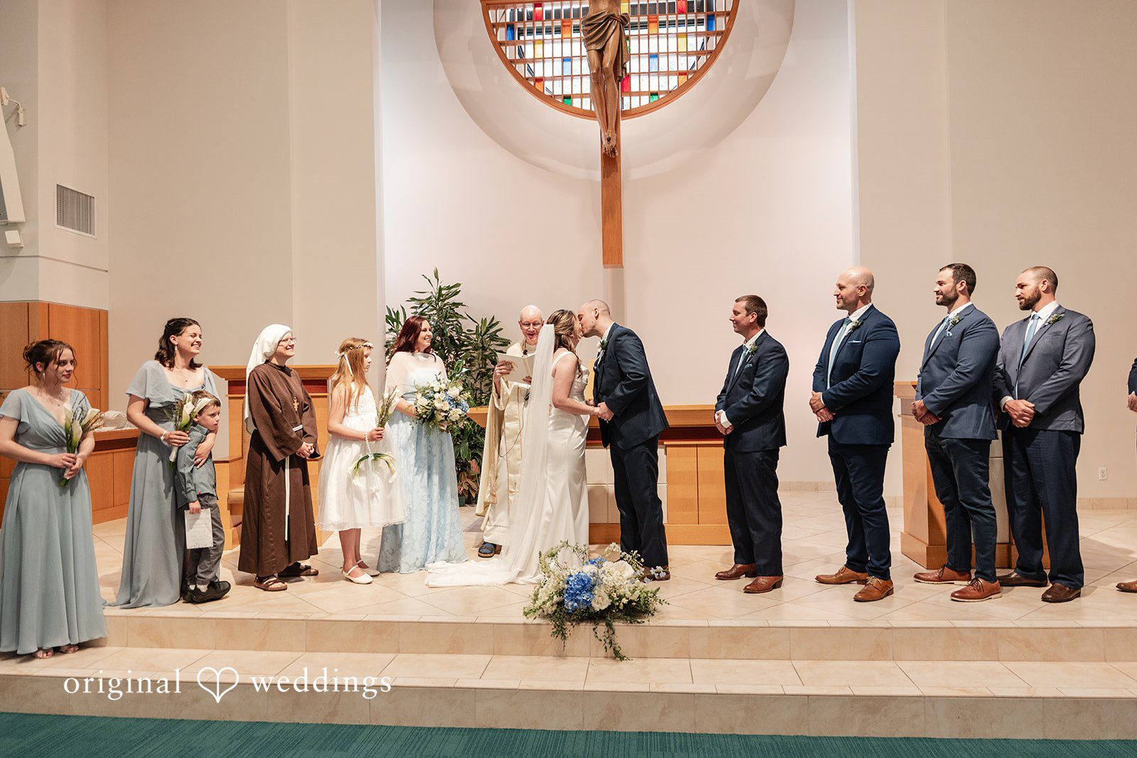 Mary Rose + Nate Couple sharing their first kiss after exchanging vows
