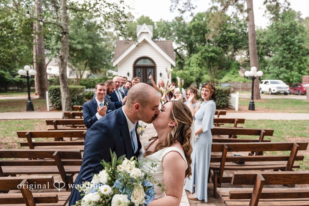 Mary Rose + Nate Bride and groom kissing surrounded by bridesmaids and groomsmen