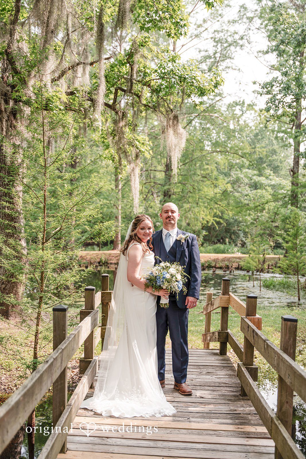 Mary Rose + Nate Full-length portrait of the couple on a lakeside dock
