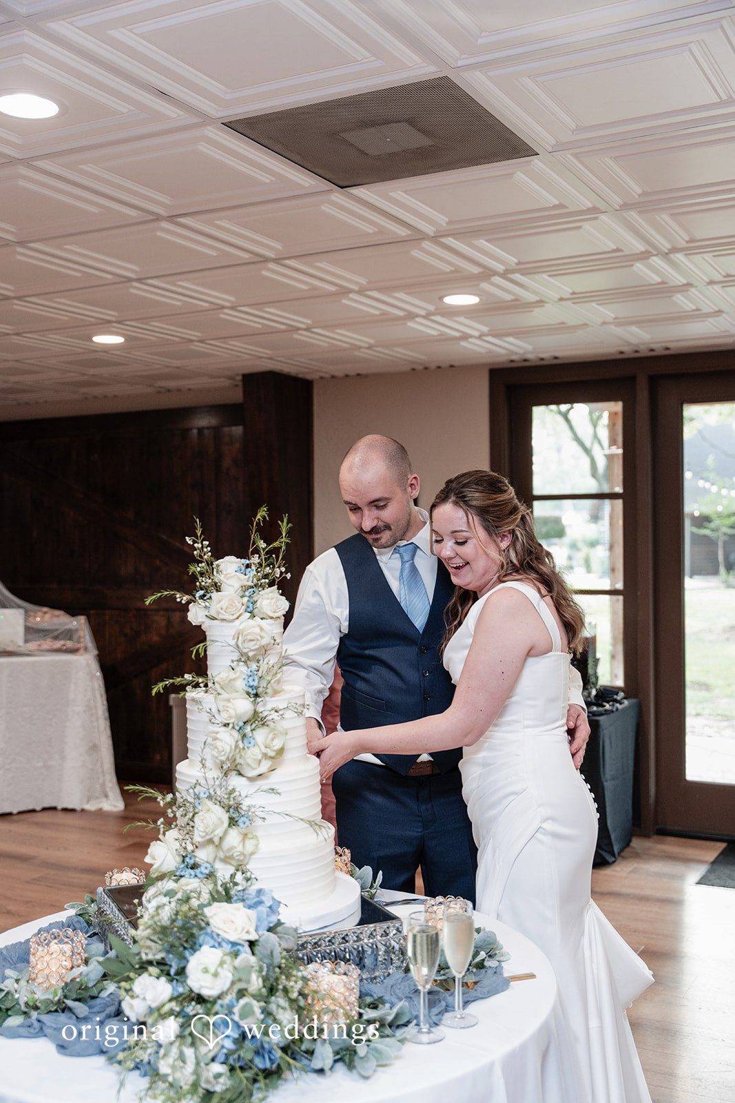 Mary Rose + Nate Bride and groom cutting their wedding cake together