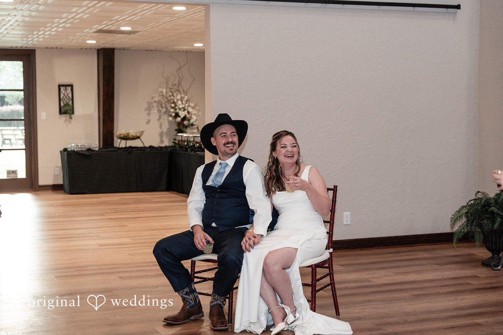 Mary Rose + Nate Couple laughing together while seated at the reception
