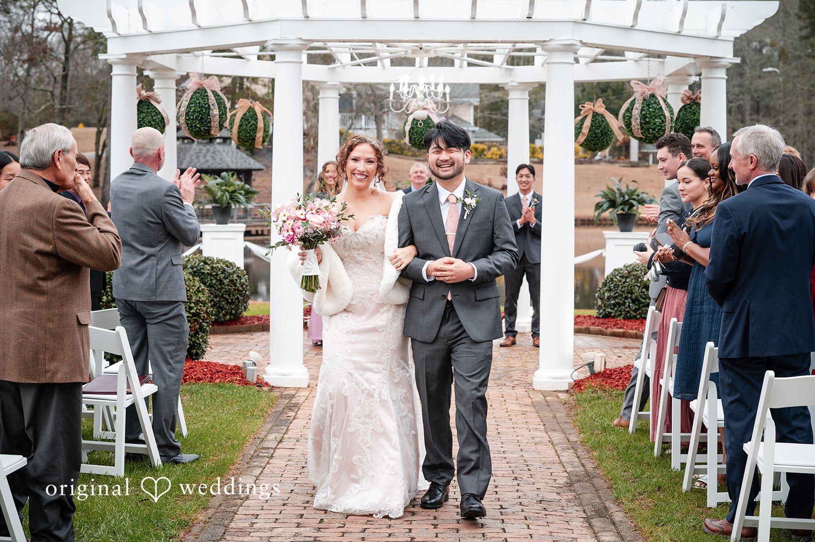 Emsley + Sean Atlanta Wedding Photographers capturing bride and groom walking outdoors together at The Farley Estate by Original Weddings