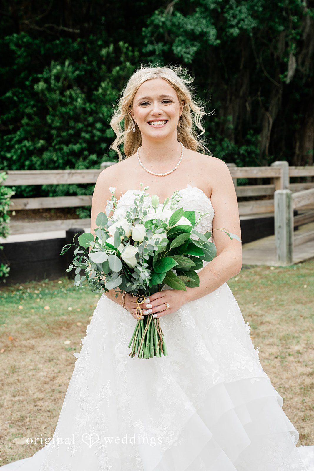 Madeline + John Full-length bridal portrait holding a bouquet outdoors