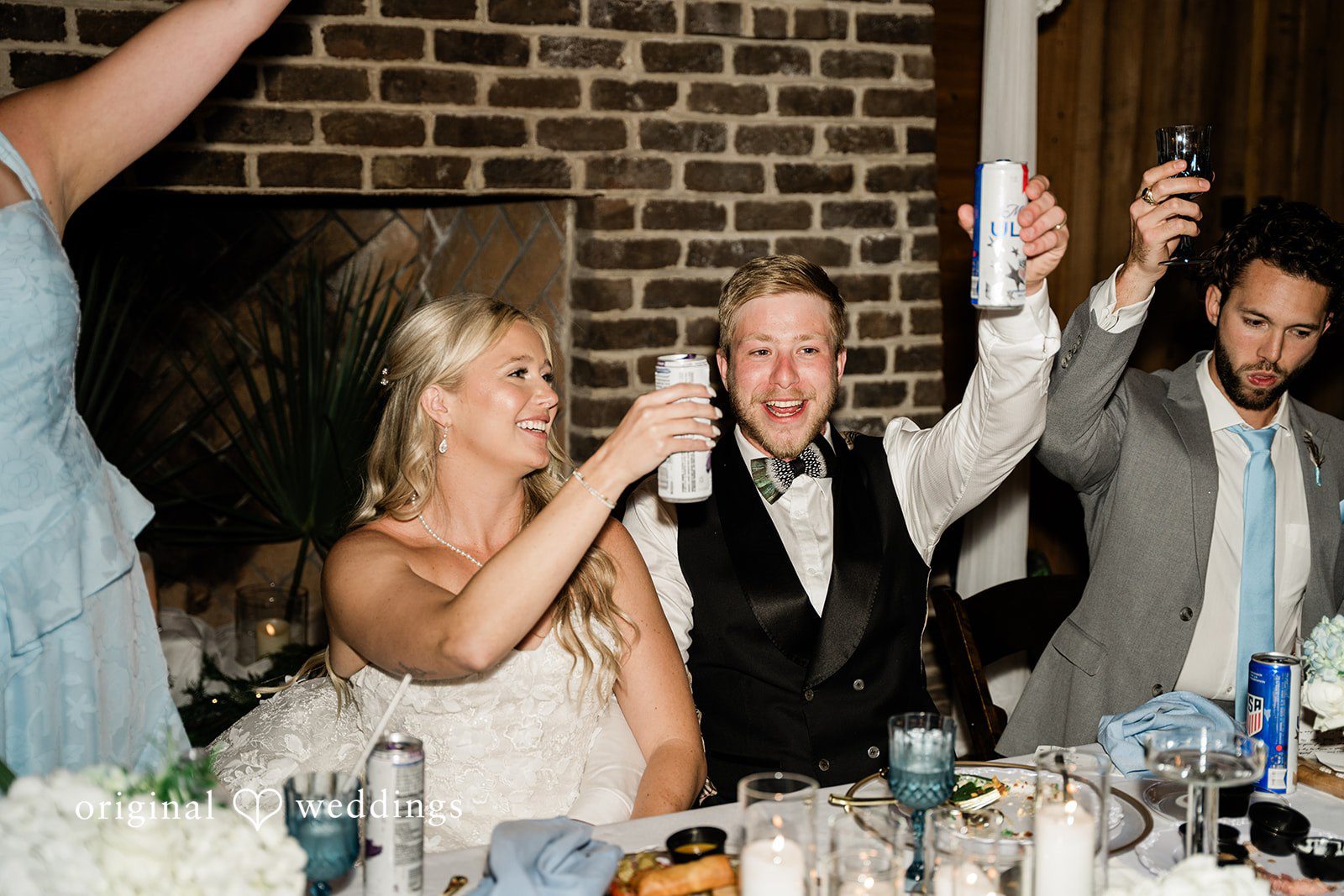 Madeline + John Newlyweds laughing together at their reception table