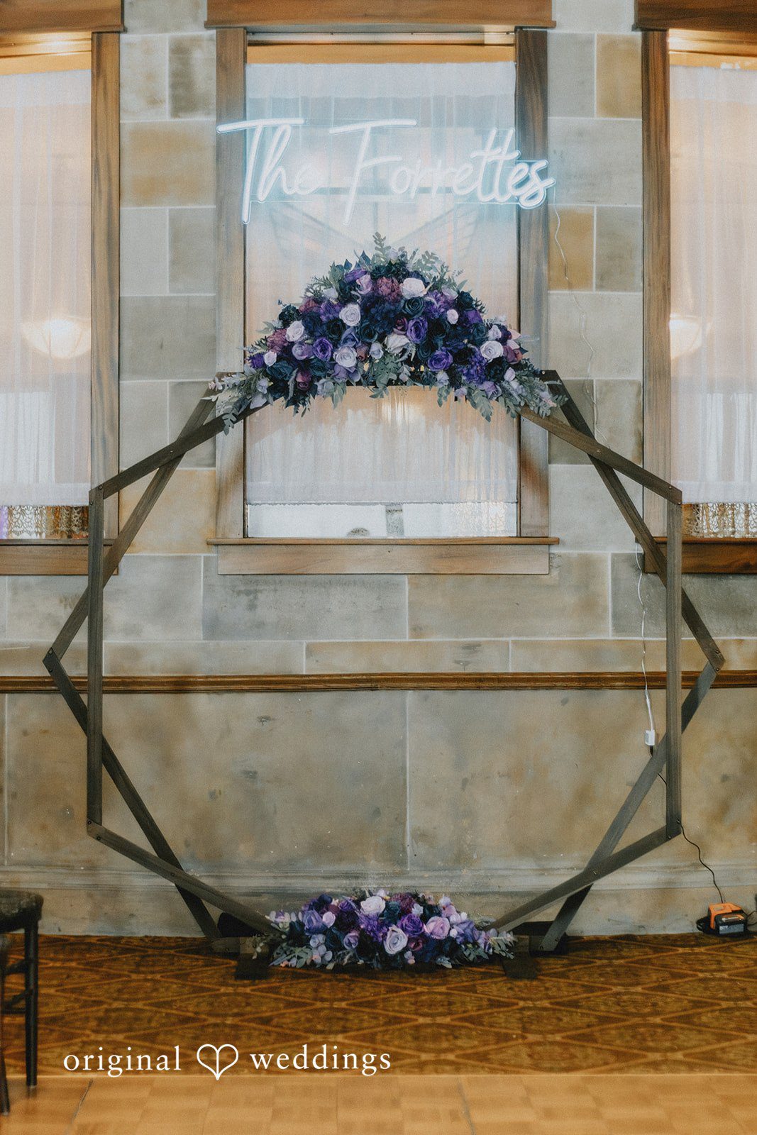 The ceremony arch adorned with fresh florals