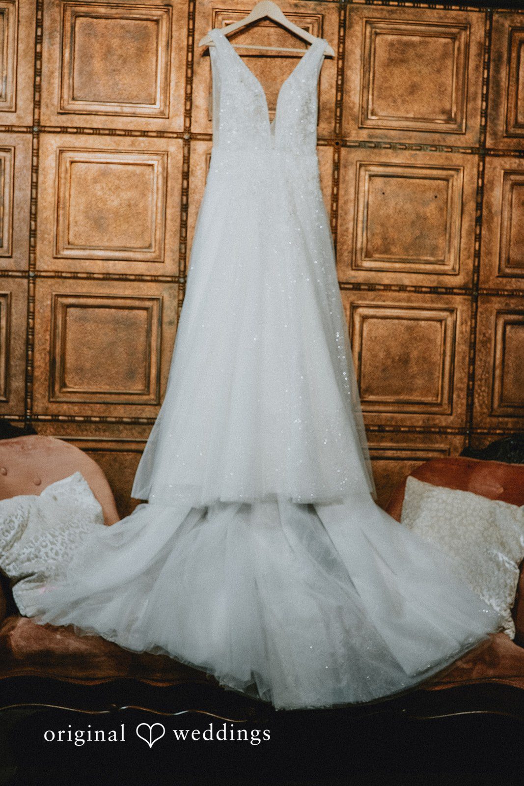 The bride's gown gracefully hanging in the suite