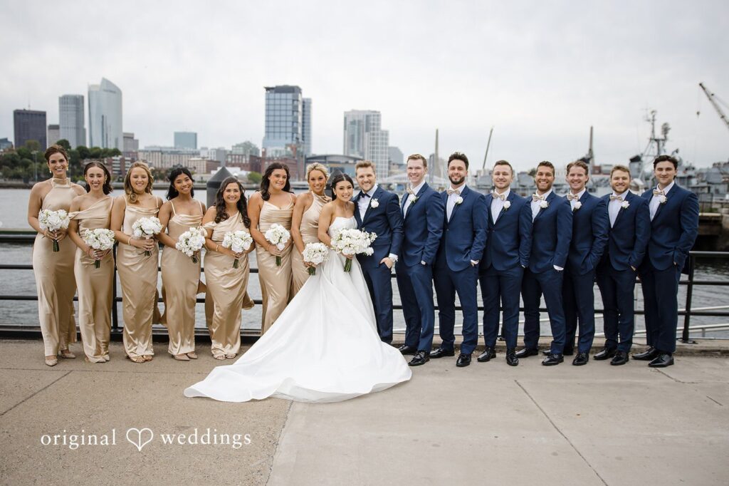 Nathan + Ainsley Our Boston wedding photographers at Original Weddings captured a stunning portrait of the couple and their bridal party by the waterfront at The State Room