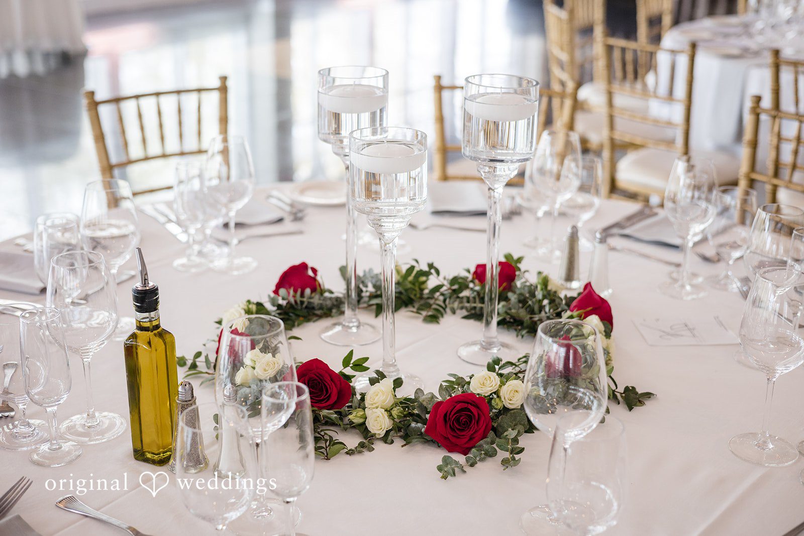 Romantic rose centerpiece with floating candles on reception table at The Waterview
