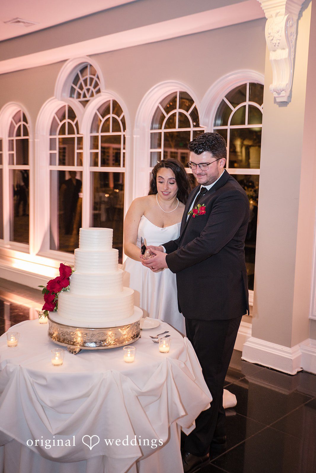 Bride and groom cutting wedding cake during reception