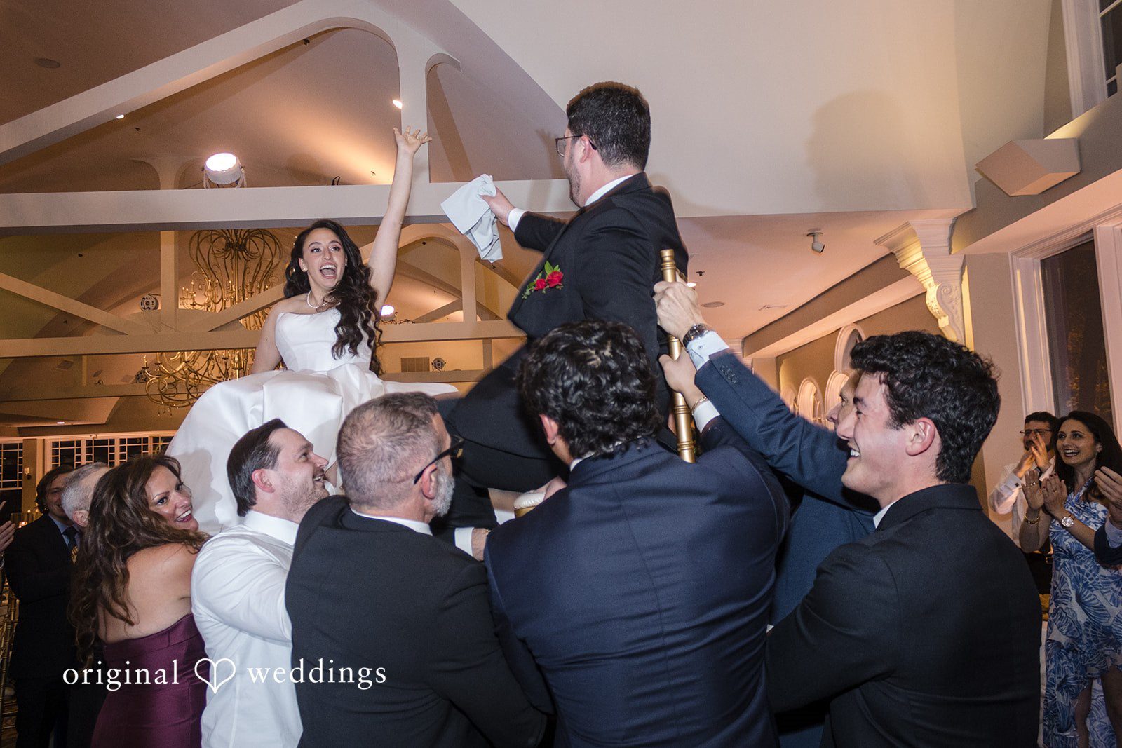 Traditional reception celebration with bride and groom raised high