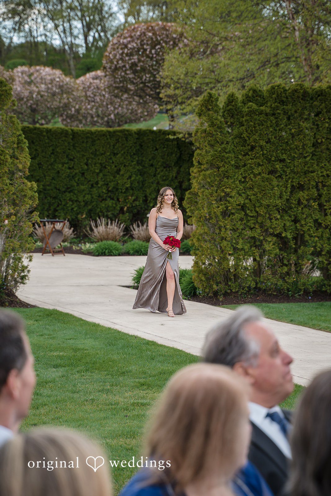 Bridesmaid walking gracefully during wedding ceremony at The Waterview