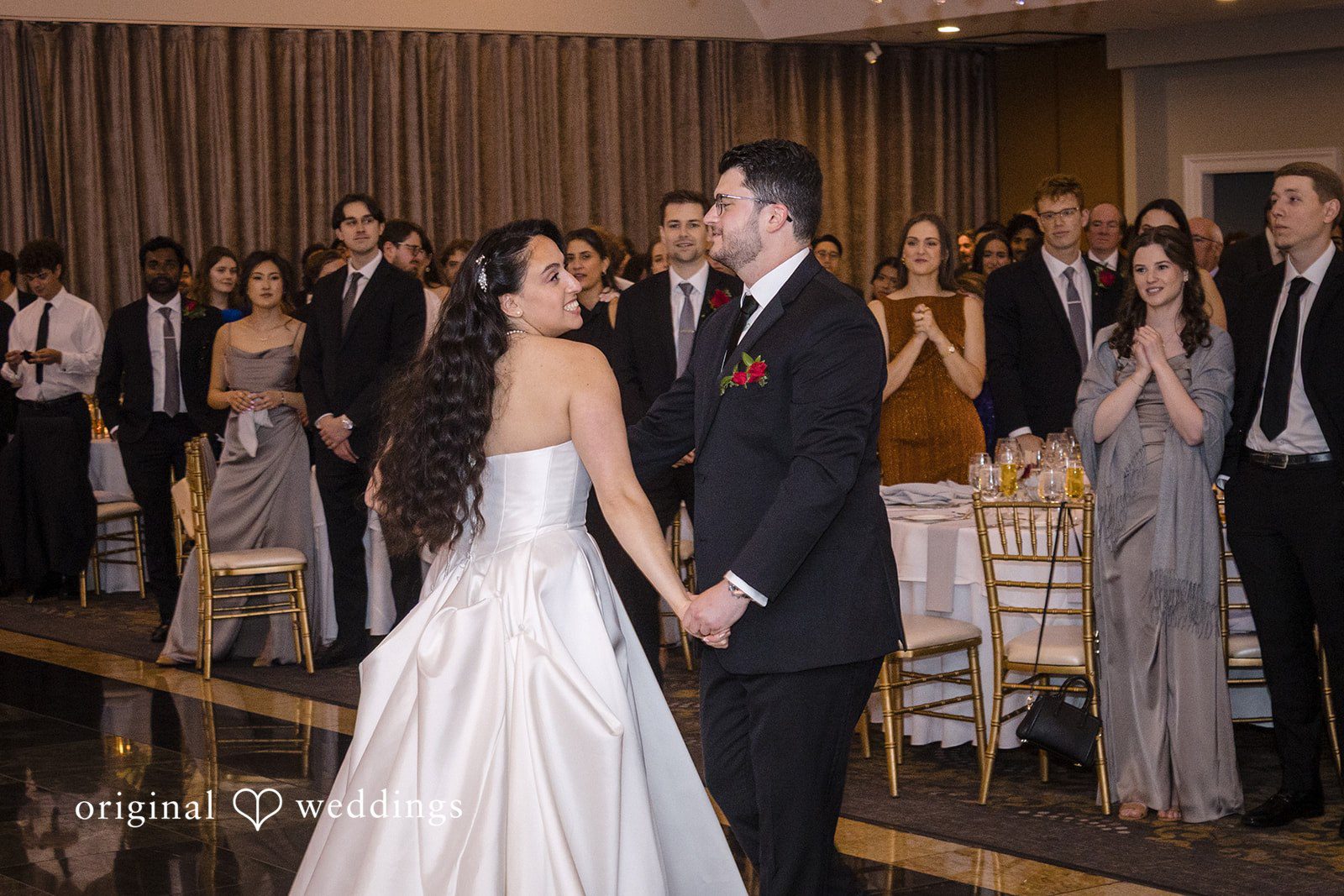 Romantic first dance surrounded by wedding guests