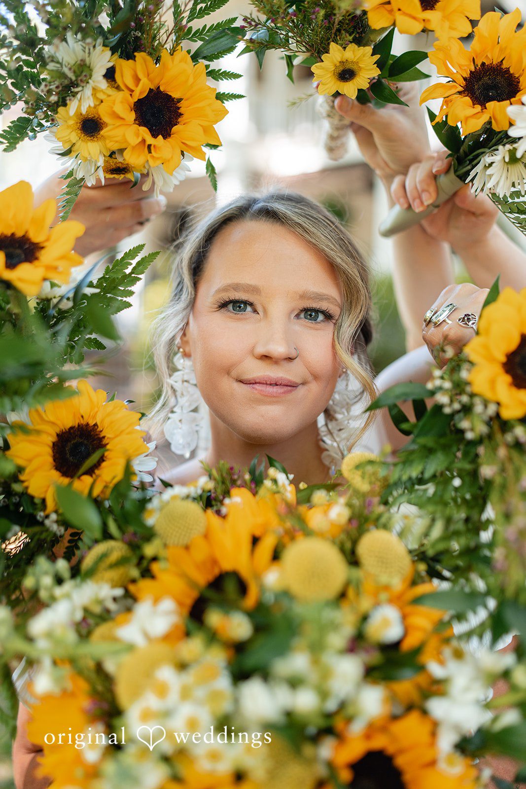 Elizabeth + Zodi Bride surrounded by flowers in a romantic portrait