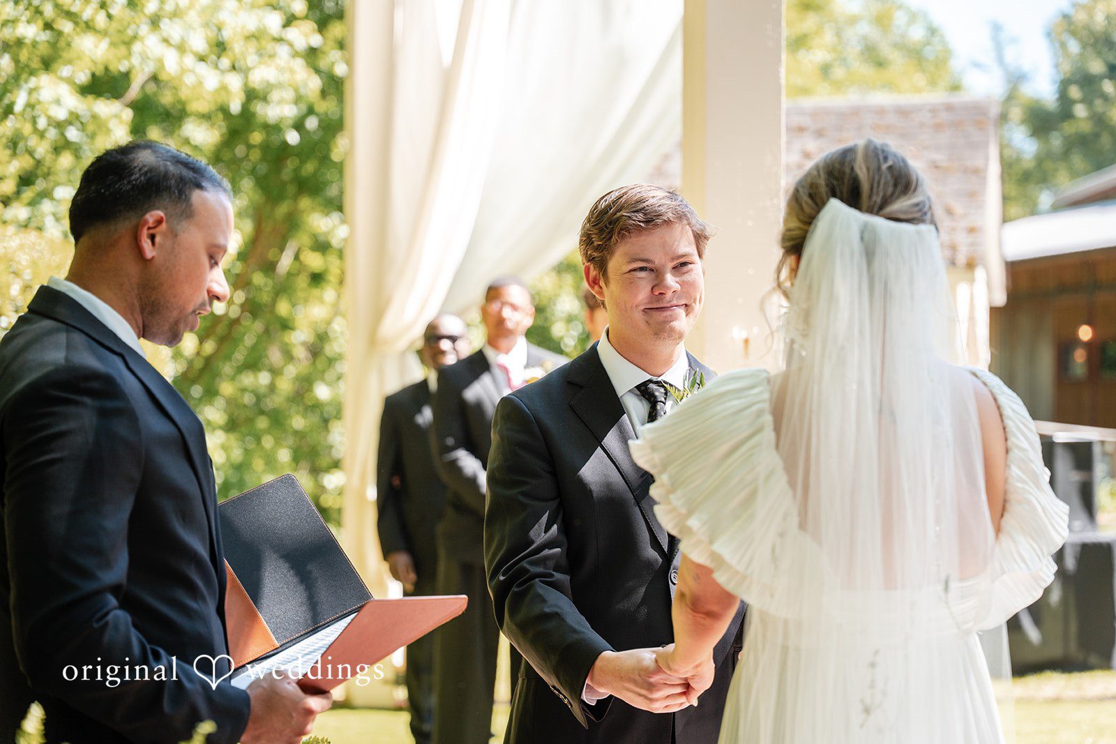 Elizabeth + Zodi Bride and groom holding hands during the ceremony