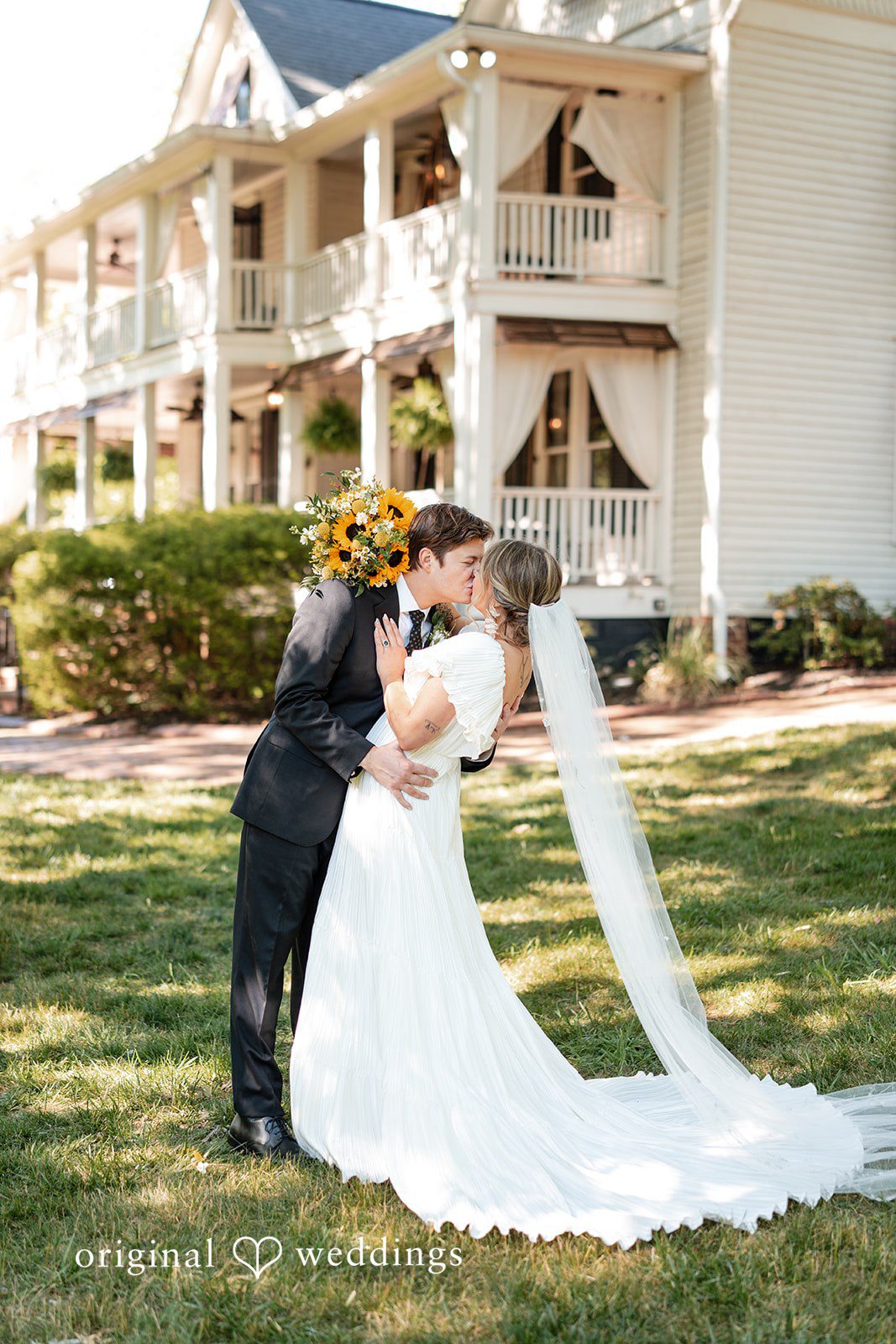 Elizabeth + Zodi Full-length portrait of the bride and groom embracing in the garden