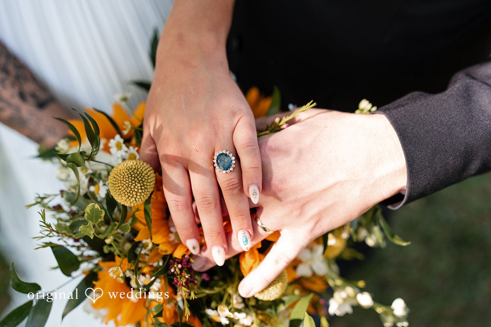 Elizabeth + Zodi Close-up of the couple’s hands displaying their wedding rings