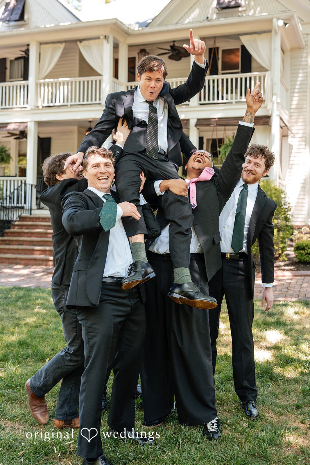 Elizabeth + Zodi Groomsmen lifting the groom during a fun wedding moment