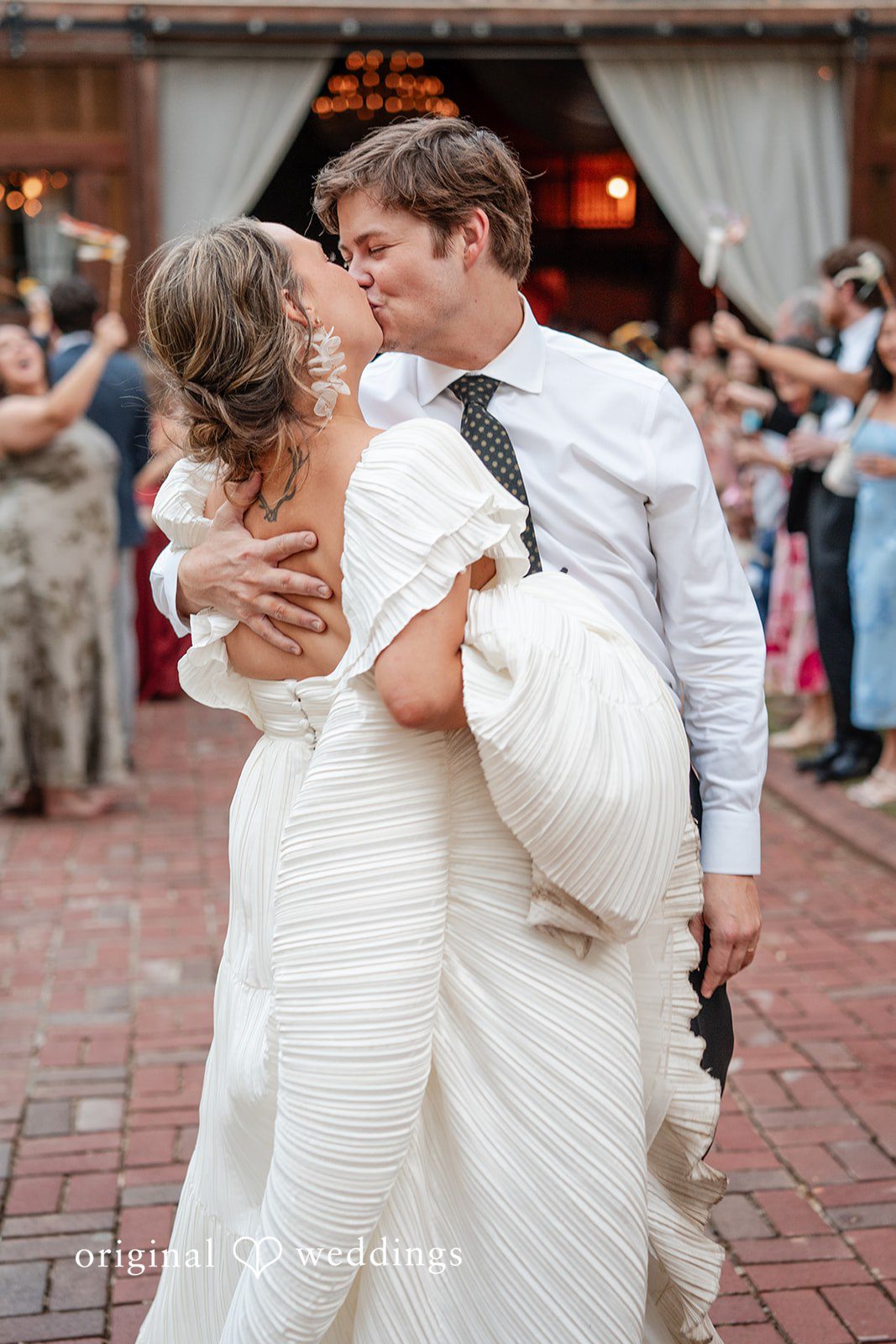 Elizabeth + Zodi Newlyweds walking together as they leave the reception