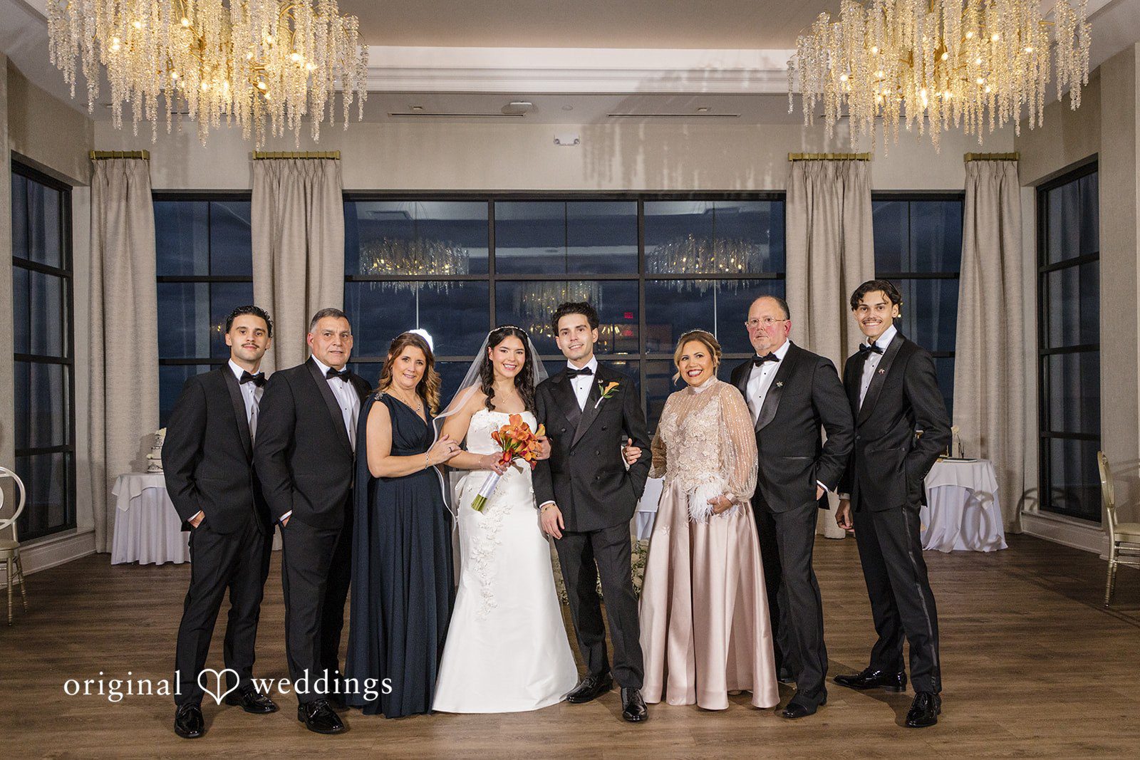 Maria + Eddy A wedding party poses together in formal attire at Tyde at Walnut Beach.