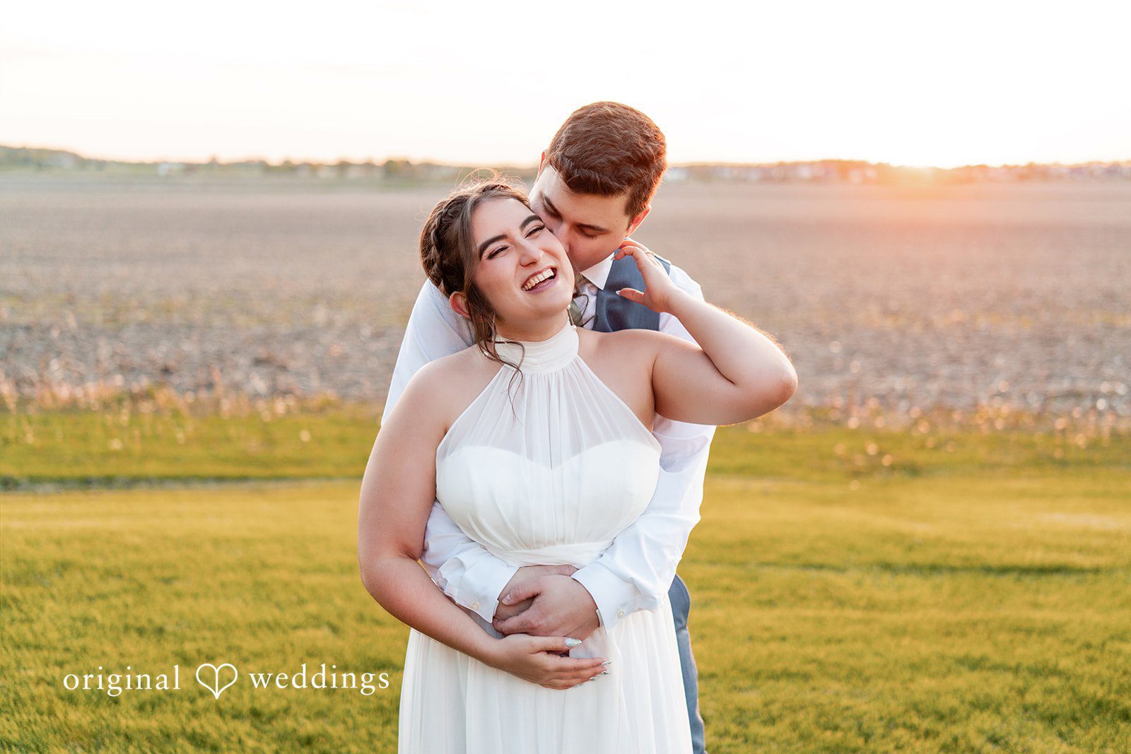 Bride and groom embracing at sunset during their wedding portraits.