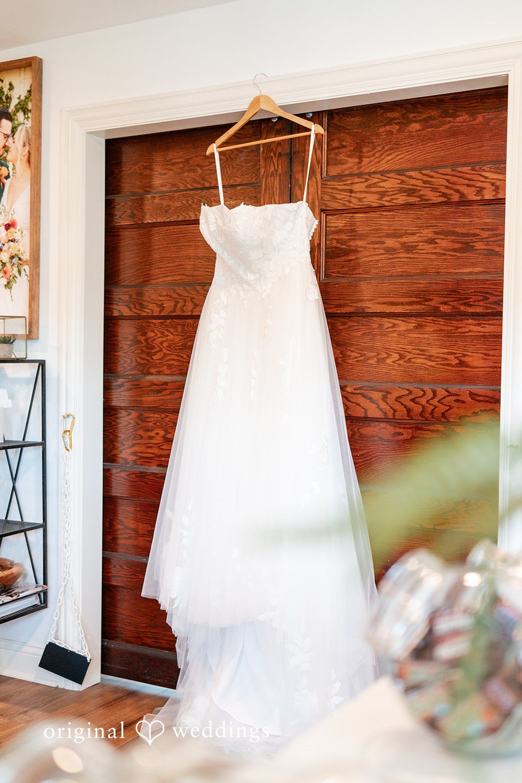 Beautiful bridal wedding gown hanging against the door.