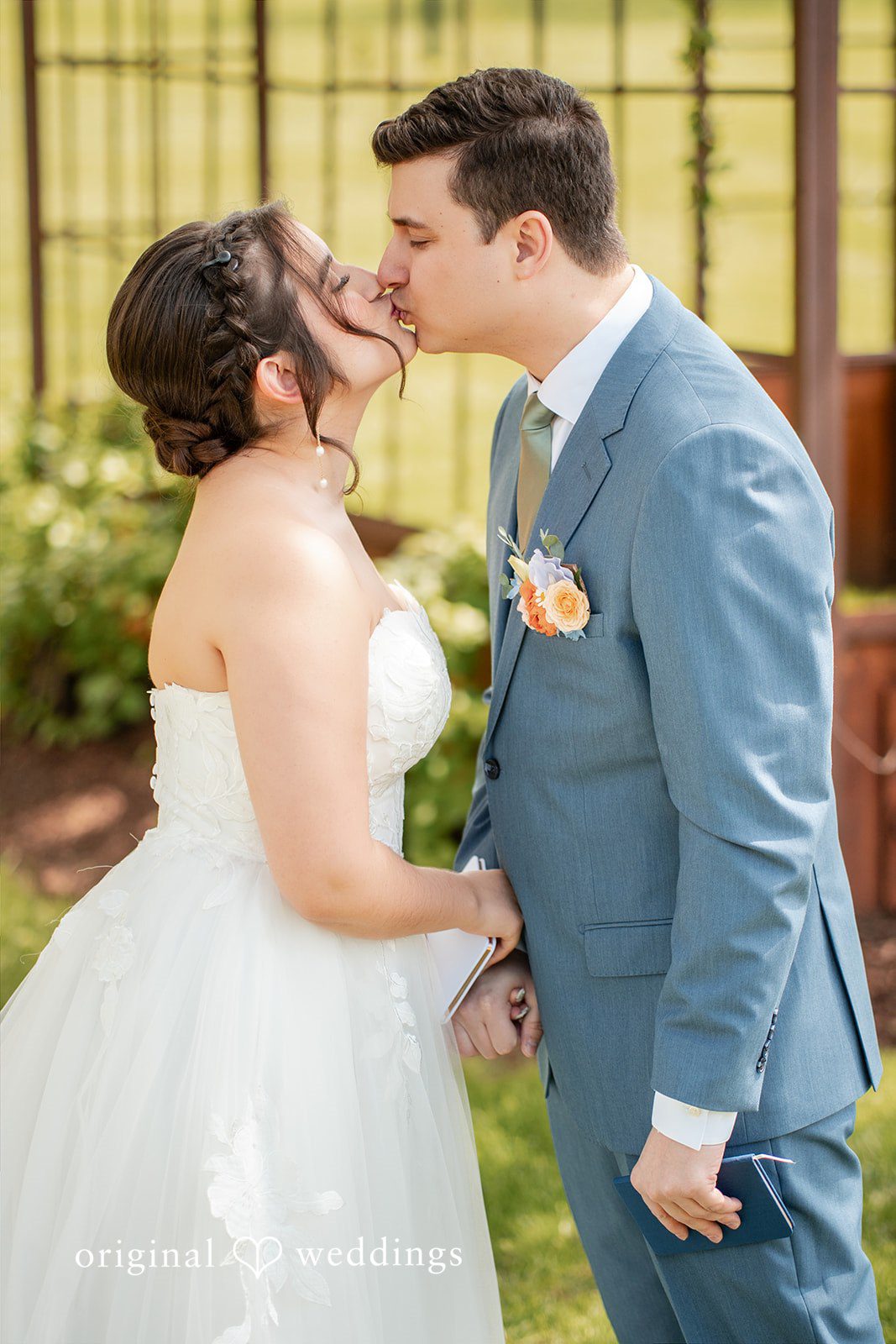 Bride and groom sharing a kiss after exchanging vows.