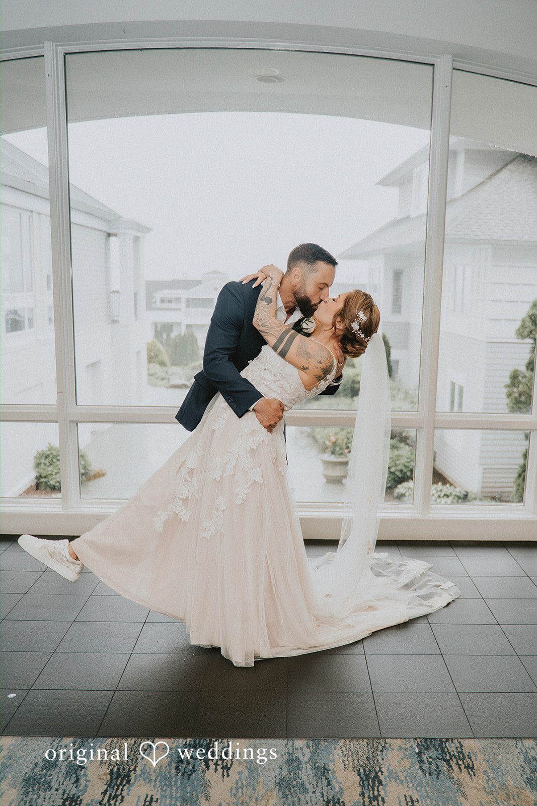 Taylor + David Bride and groom embracing indoors during a romantic wedding portrait