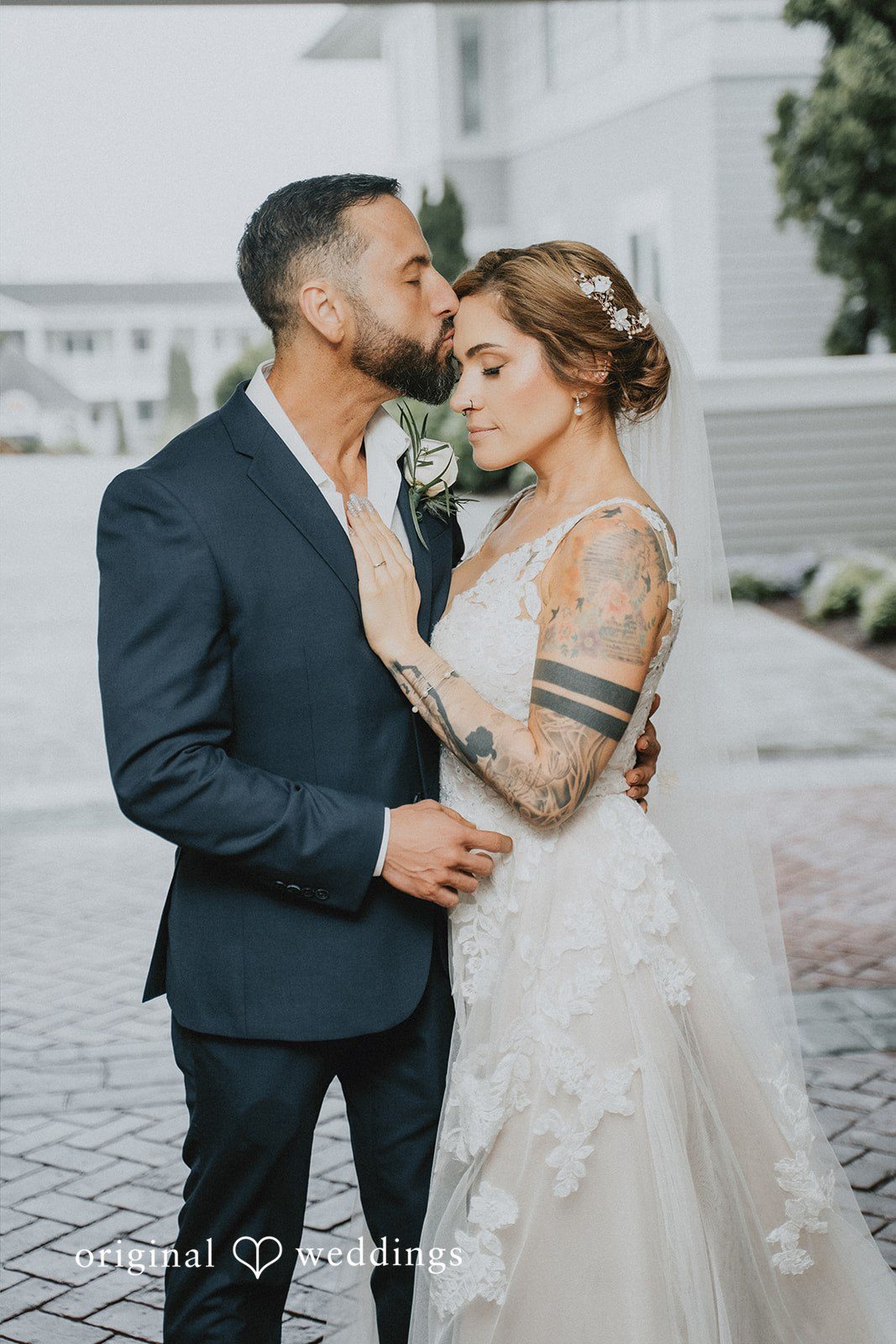 Taylor + David Groom kissing the bride on the forehead in a romantic portrait
