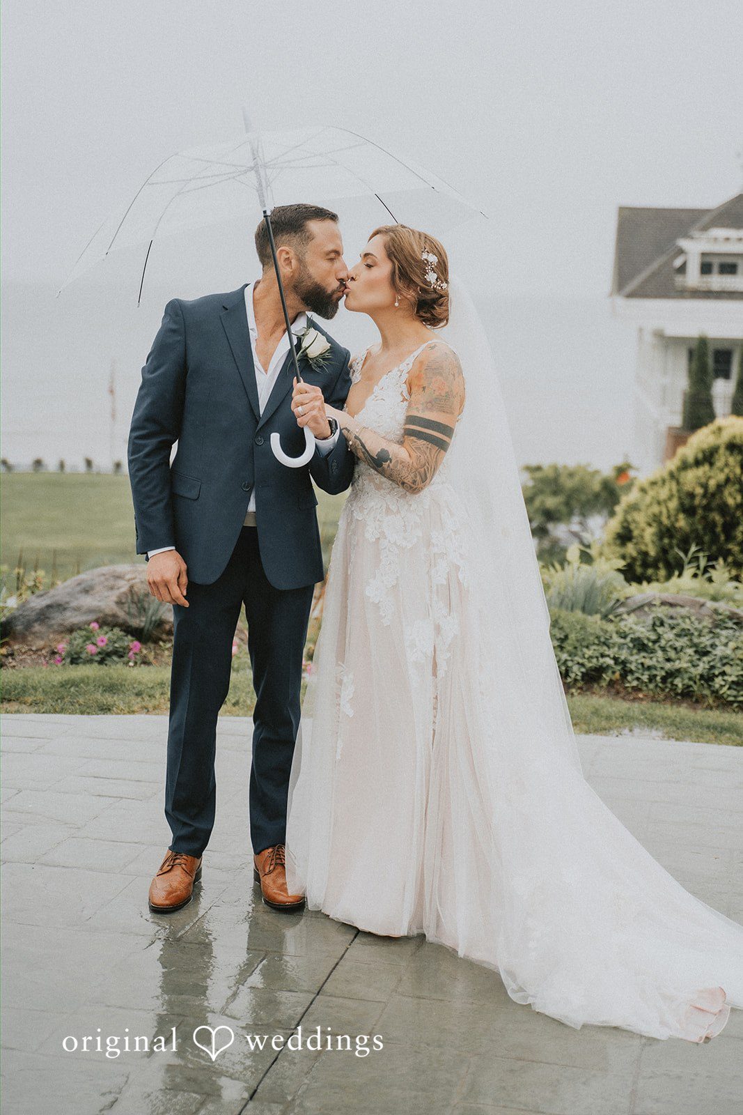 Taylor + David Bride and groom holding an umbrella outside in a stylish wedding portrait