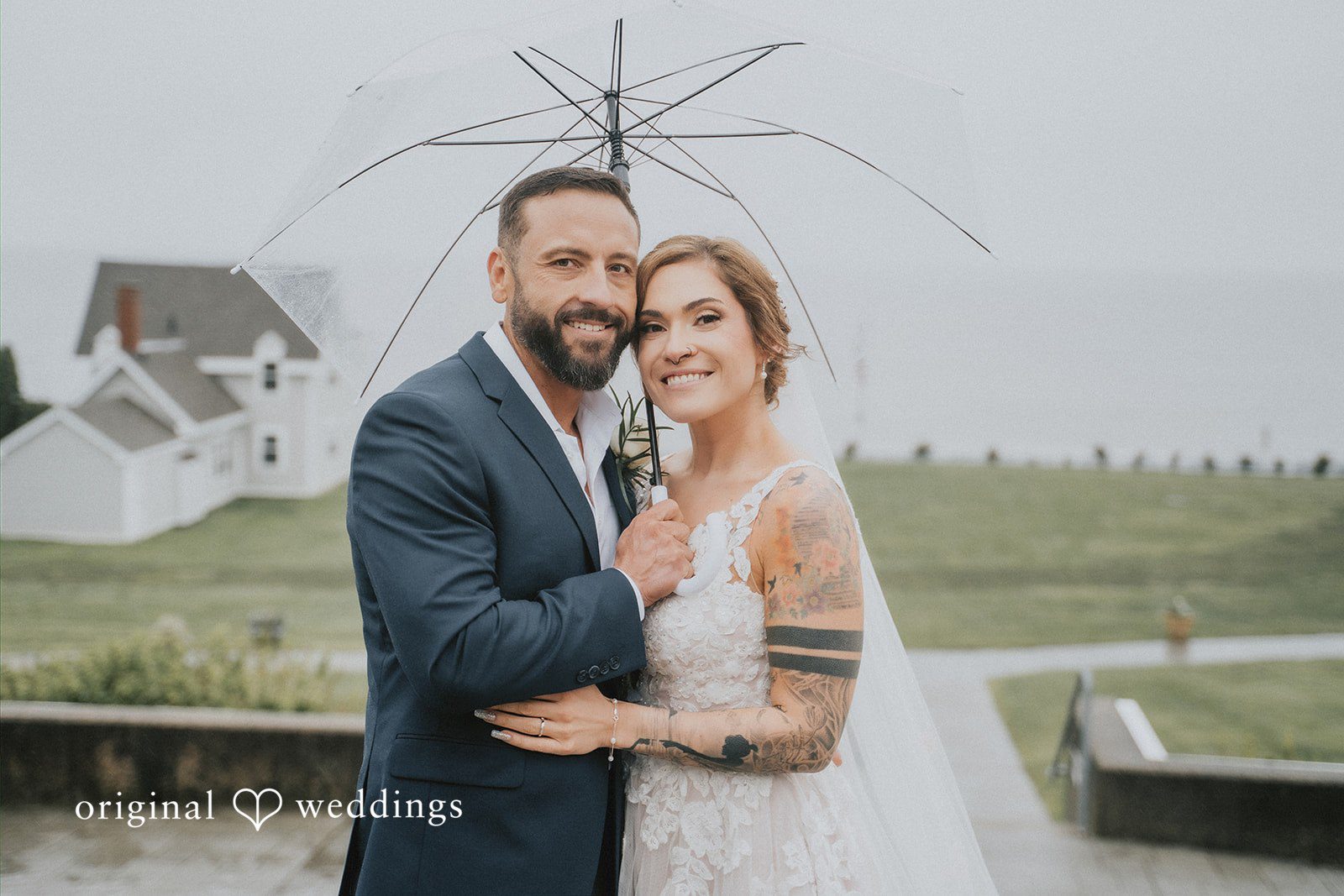 Taylor + David Bride and groom posing by the waterfront in a romantic coastal portrait
