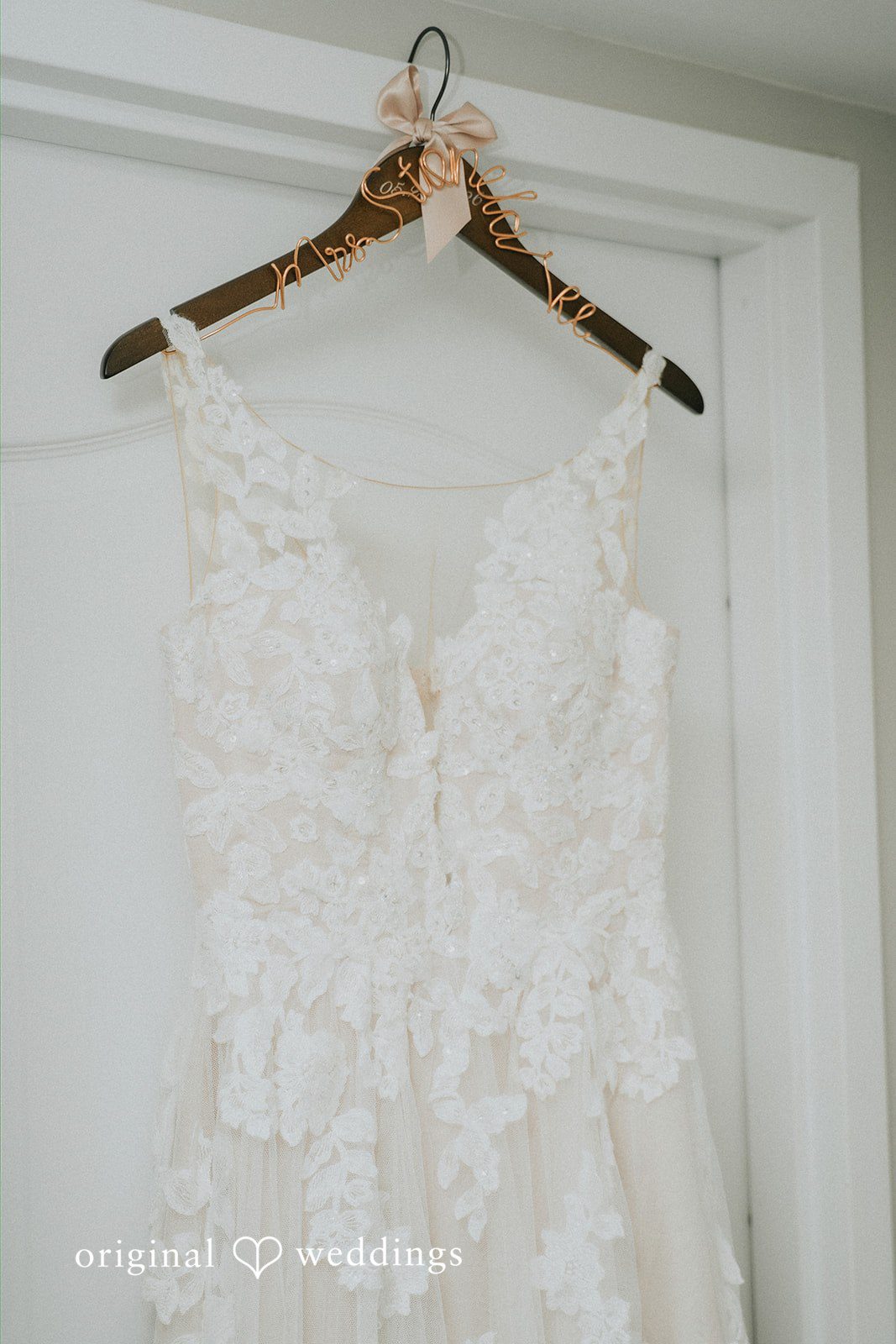 Taylor + David Wedding dress hanging before the ceremony at Watersedge Resort and Spa