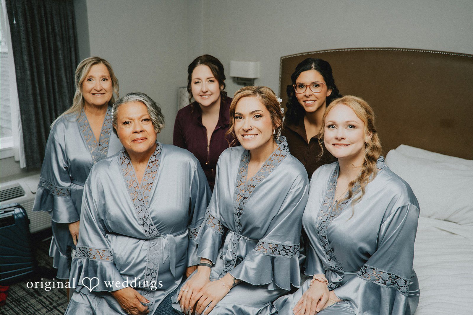 Taylor + David Bride posing with her bridesmaids before the wedding ceremony