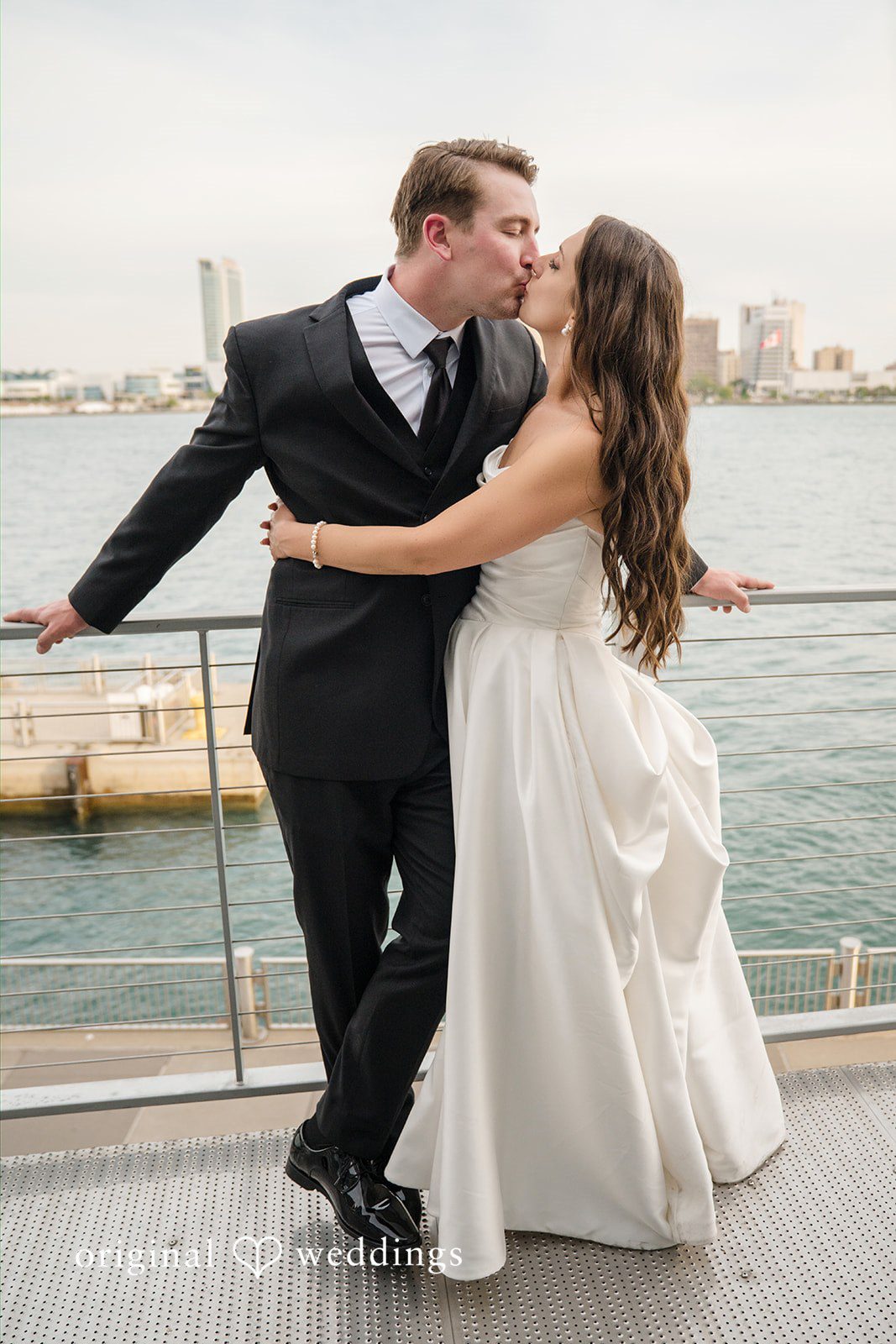 Ann + Justin The couple shares a kiss by the waterfront