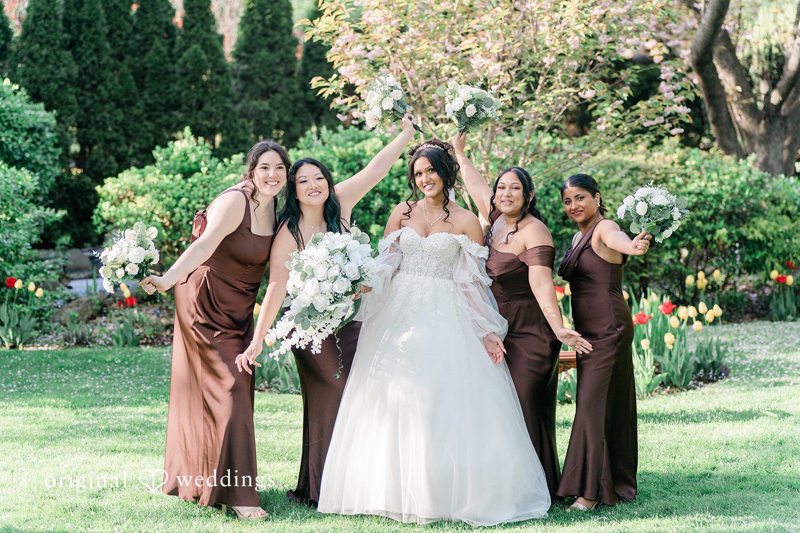 Sabrina + Jonathan Picture of bride with bridesmaids posing with bouquet.