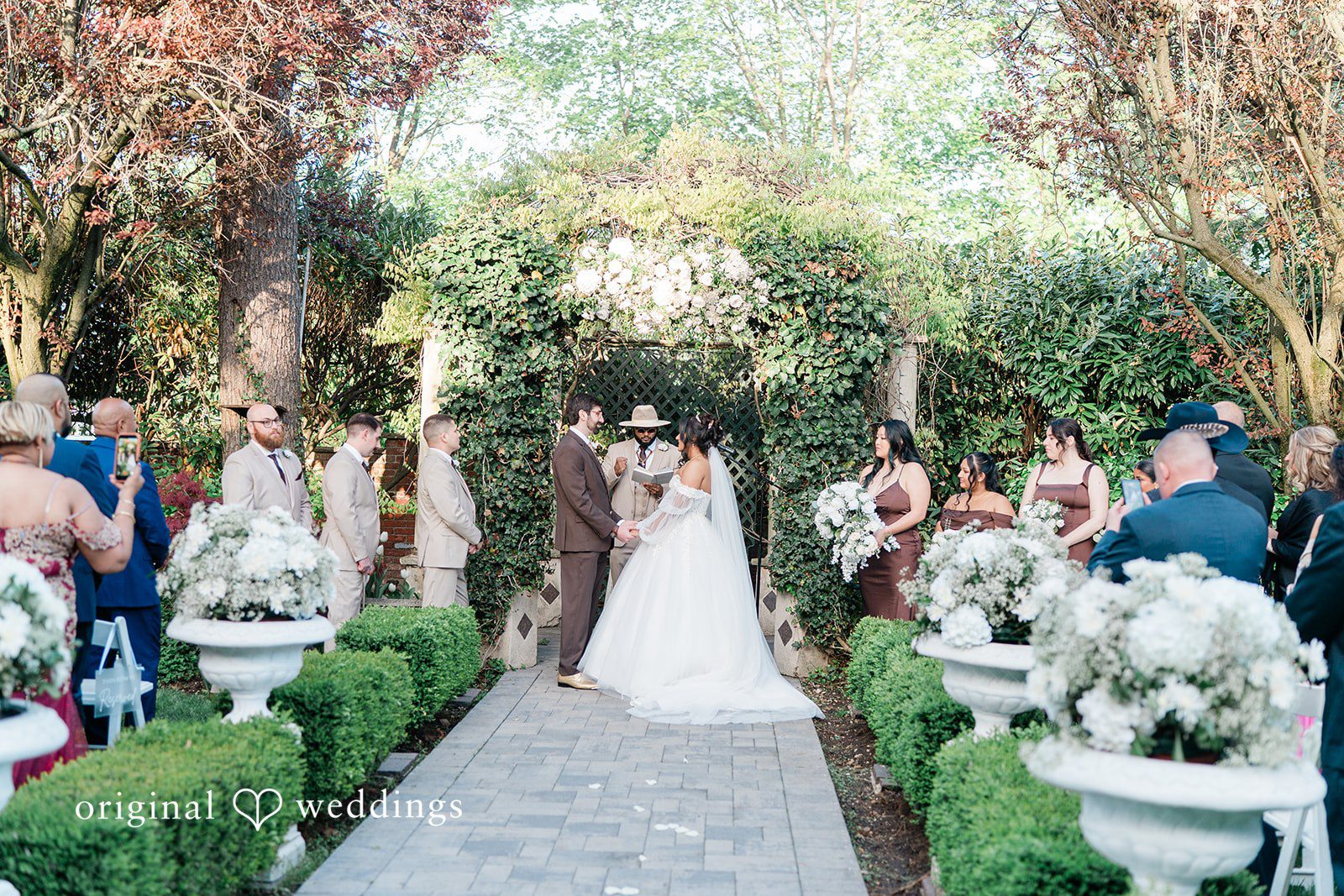 Sabrina + Jonathan Bride and groom exchanging vows during wedding ceremony at Westbury Manor
