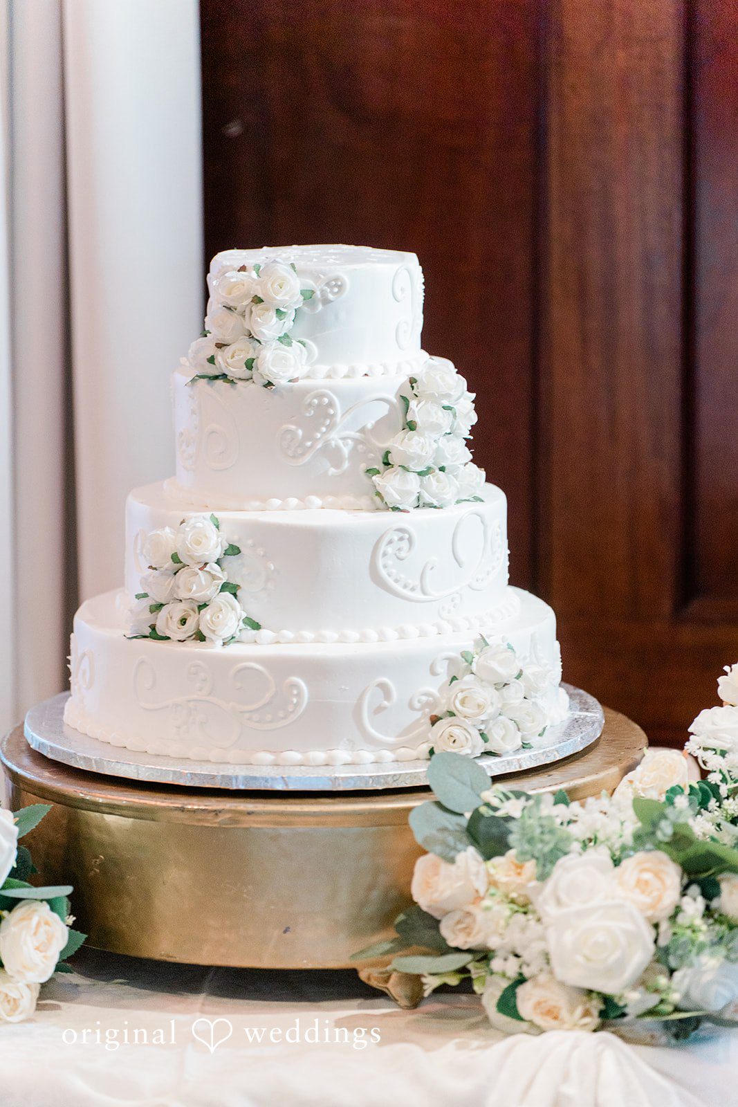 Sabrina + Jonathan Shot of wedding cake decorated with white flowers