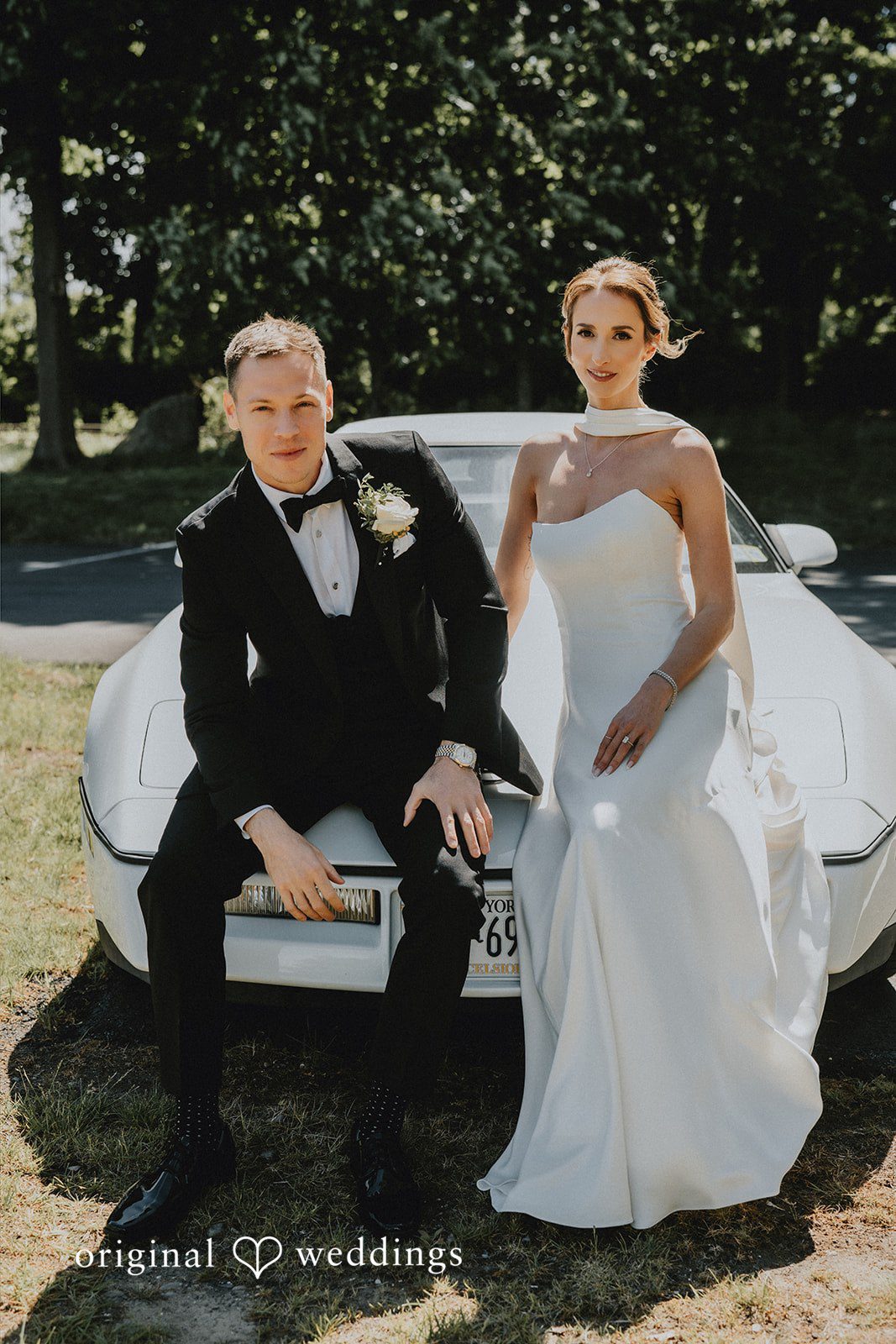 A stunning portrait of the couple by their sleek white car