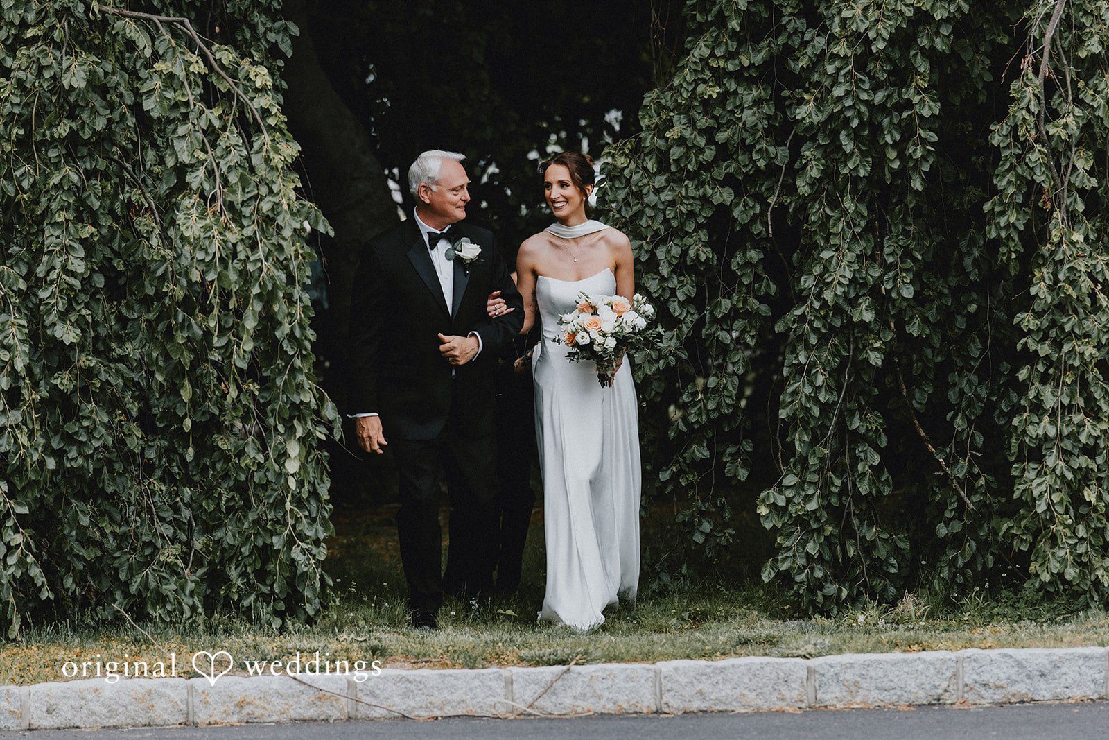 The bride's father escorts the bride down the aisle