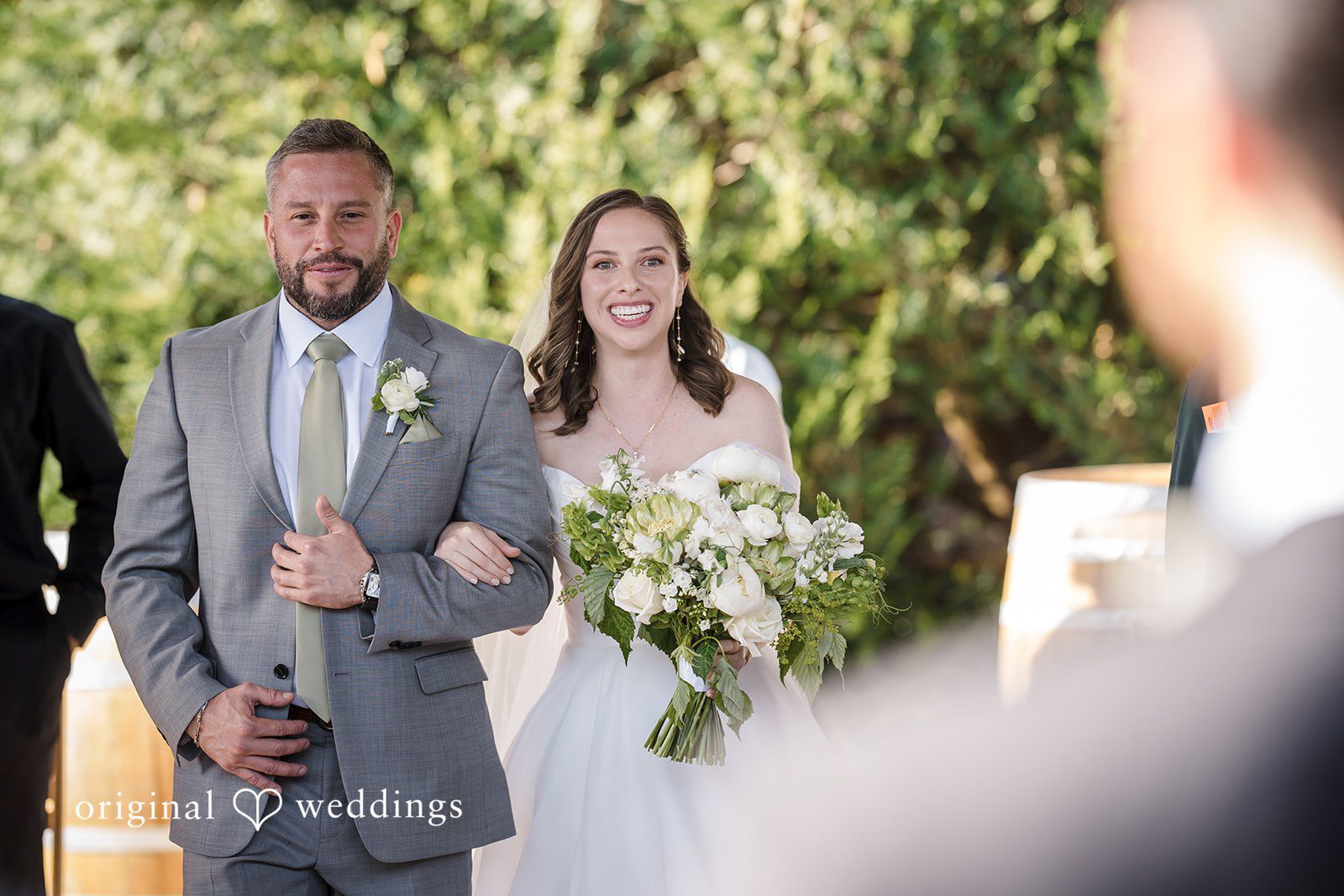 Lovely bride walking down the aisle with a man at Willows Lodge