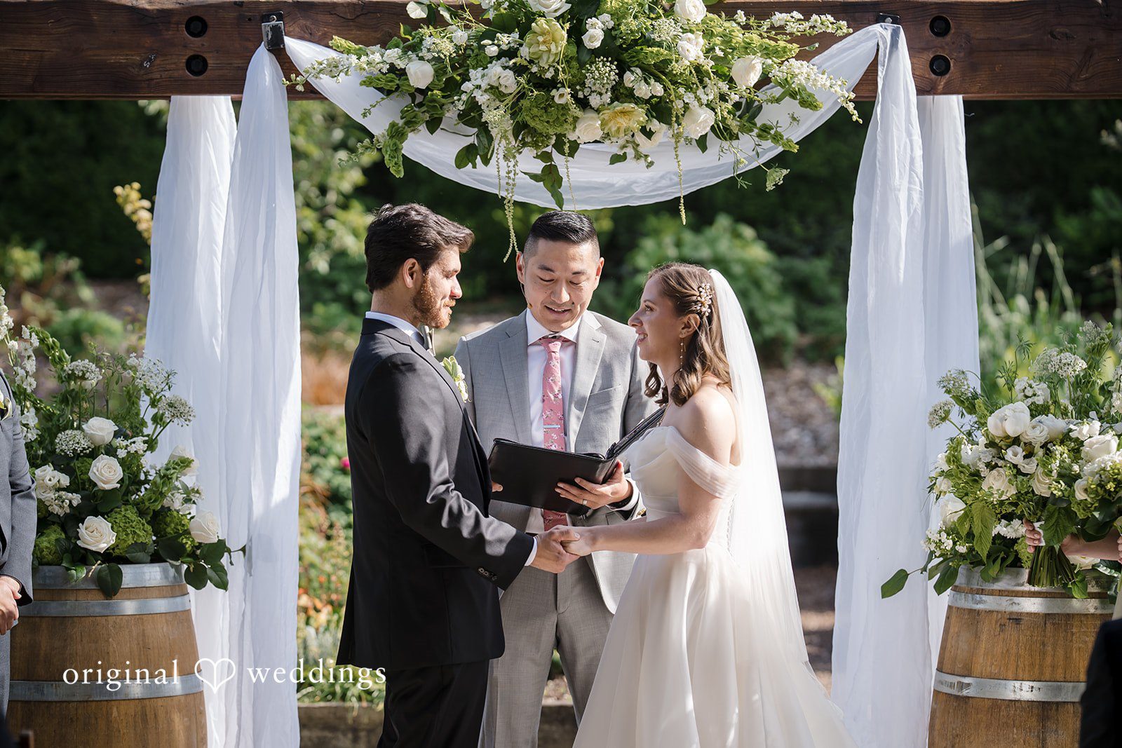 Couple exchanging vows during wedding ceremony at Willows Lodge captured by Seattle wedding photographers from Original Weddings