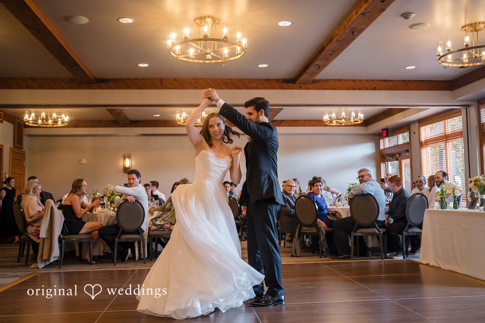 Bride twirling around the groom at dance floor